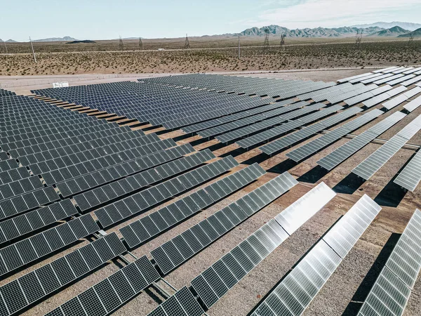Renewable solar energy solar farm in the desert of southern Nevada on a dry lake bed gathering sun rays and photovoltaic energy to provide sustainable electricity to nearby Las Vegas and other surrounding areas to be more modern, environmental, and i