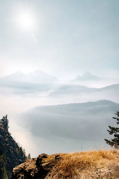 Smoke from nearby wild fires settle at diablo lake in North Cascades National Park in late summer making it difficult to see and breath and enjoy the area.