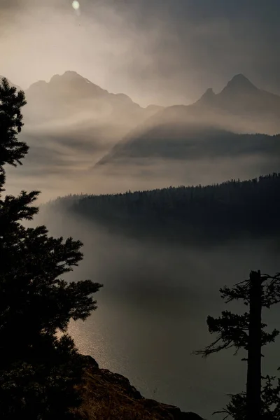 Smoke from nearby wild fires settle at diablo lake in North Cascades National Park in late summer making it difficult to see and breath and enjoy the area.