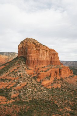 Courthouse Butte Rock in red rock formations within coconino national forest in Sedona Arizona USA against white cloud background. Horizontal Image.