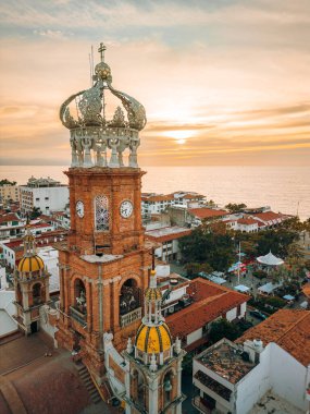 Close up aerial view of our Lady of Guadalupe church in Puerto Vallarta, Mexico with sun setting. clipart
