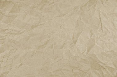  Buruşmuş bej kağıdın dokunsal dokusu. Kırışık ambalaj kağıdı arka planı. Paket kağıdı. Açık bej kağıt tonu sessiz ama sıcak renklerle zengindir..