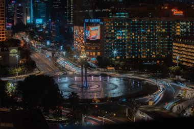 Night cityscape,and traffic light of highway in slow speed shutter motion effect and noise.Jakarta, Indonesia .January 9 2023