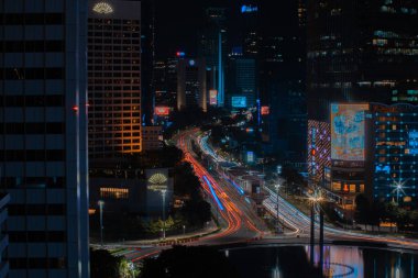 Night cityscape,and traffic light of highway in slow speed shutter motion effect and noise.Jakarta, Indonesia .January 9 2023