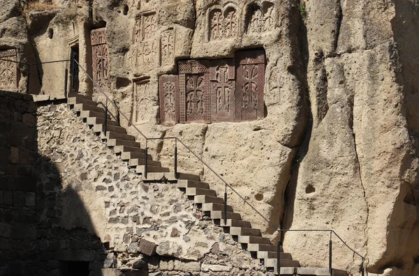 stock image Four medieval khachkars carved in the 12th century and installed in the wall of the cave Church on the territory of Geghard monastery in the mountains of Geghama ridge, Armenia.