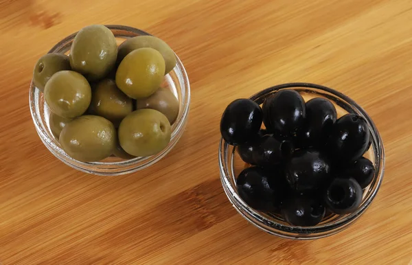 Black and green olives in glass containers. Christmas table. Shallow depth of field