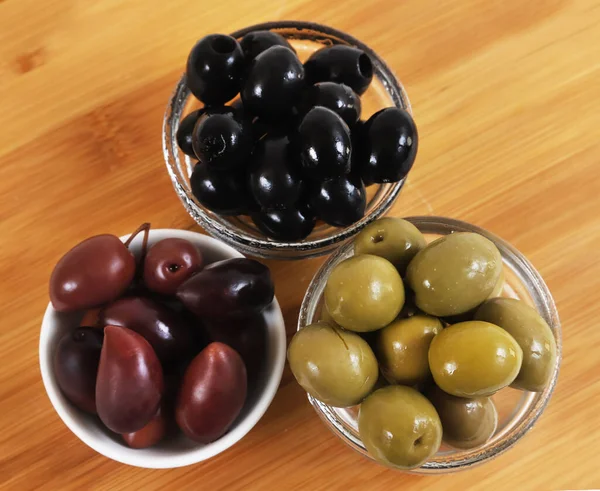 Black and green olives in glass containers. Christmas table. Shallow depth of field