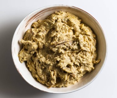 Satsivi, a Georgian poultry dish in a walnut sauce. Close-up of a Satsivi dish in a plate on a light background