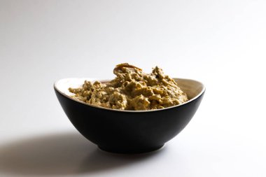 Satsivi, a Georgian poultry dish in a walnut sauce. Close-up of a Satsivi dish in a plate on a light background