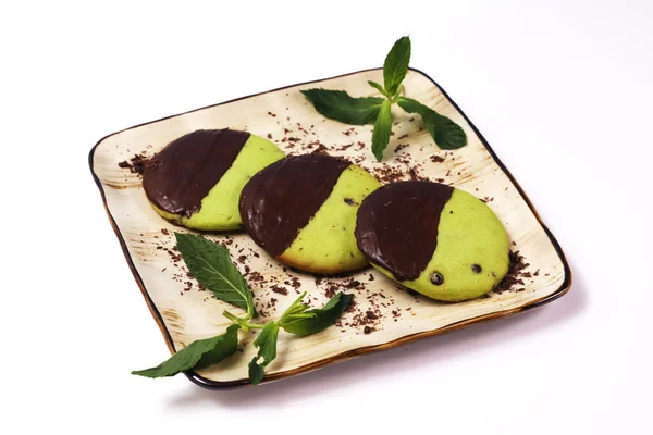 Cookies with pistachio and chocolate coating. Close-up
