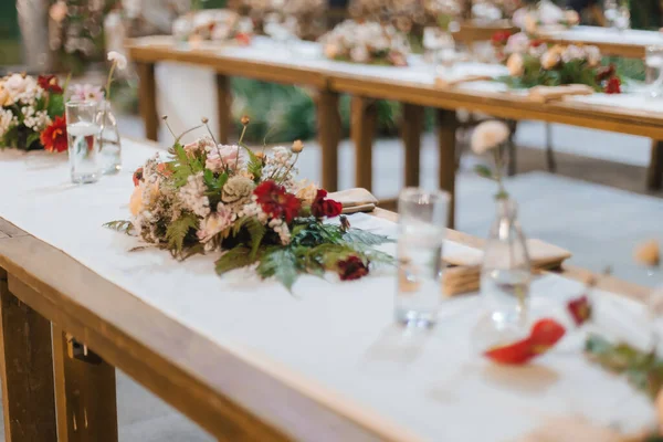 Wedding reception night dinner setup table with beautiful flower decoration.