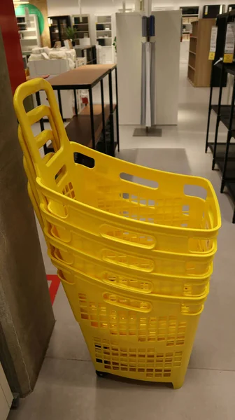 Yellow shopping baskets at shopping mall.