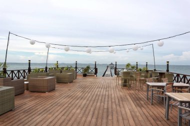 Outdoor cafe near beach with ocean background good for hangout and night party or wedding party.