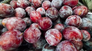 Pile of cherry plum or red plum display at the market.