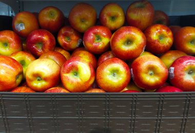 Pile of apple in the box container at the market for sale.