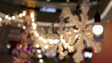 Winter light decoration, artificial snow, light bulb and Christmas decoration, seasonal greetings.