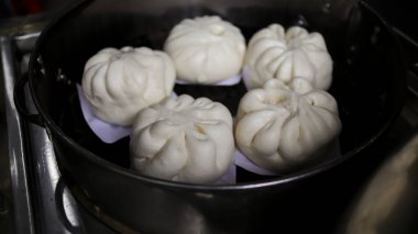Siaupao or pork bun or steamed buns or siopao pork in a stainless streamer.