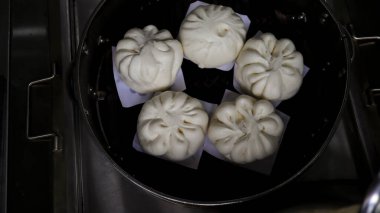 Siaupao or pork bun or steamed buns or siopao pork in a stainless streamer.