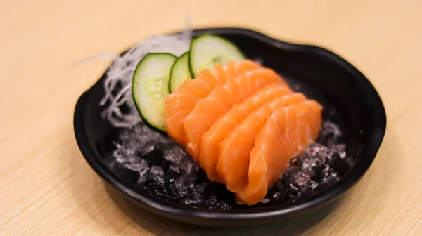 Sliced raw salmon fish or salmon fillet or salmon sashimi as Japanese food restaurant. Asian food Japan sushi restaurant menu.