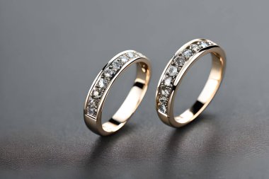 Captivating close up shot of two wedding rings, delicately intertwined to symbolize the everlasting bond of love and commitment. Jewelry gold diamond ring for anniversary, valentine, or engagement