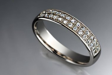 stunning close up shot of a single wedding rings, delicately intertwined to symbolize the everlasting bond of love and commitment. Jewelry gold diamond ring for anniversary, valentine, or engagement