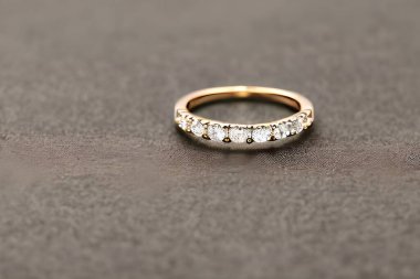 stunning close up shot of a single wedding rings, delicately intertwined to symbolize the everlasting bond of love and commitment. Jewelry gold diamond ring for anniversary, valentine, or engagement