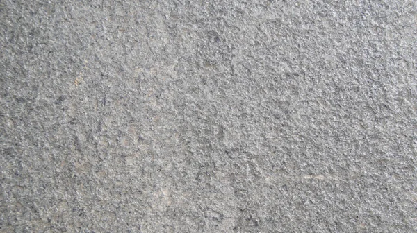 粗い灰色の石の表面のマクロビューを閉じます 自然環境で撮影された詳細な自然背景またはパターンテクスチャ — ストック写真