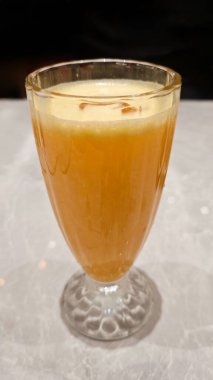 Taze sıkılmış Portakal Suyu Zarif Bardakta Mermer Masada Yumuşak Işıklandırma Arkaplanı