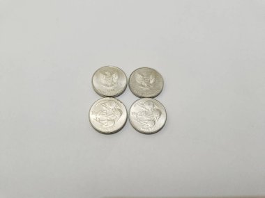 25-rupiah Indonesian money coins.
