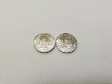 one-hundred rupiah Indonesian money coins.
