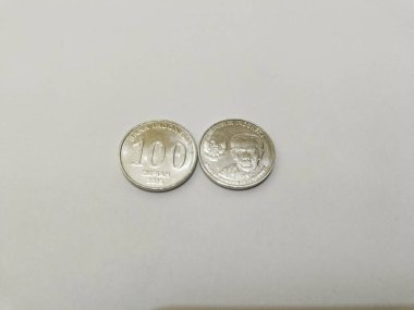 one-hundred rupiah Indonesian money coins.