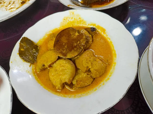 a plate of Indonesian dishes. jengkol stew 