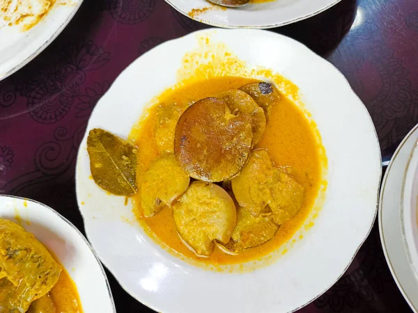 a plate of Indonesian dishes. jengkol stew 