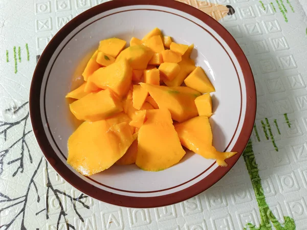 A plate of slices of mango on the table