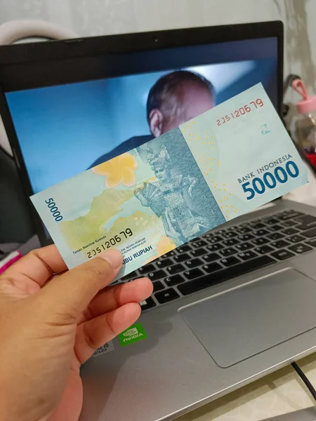 Fifty thousand rupiah Indonesian bank notes money.