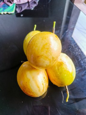 Passiflora edulis, commonly known as passion fruit are on the glass table. 