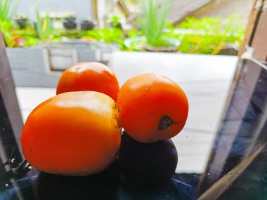 Three ripe red tomatoes on the table