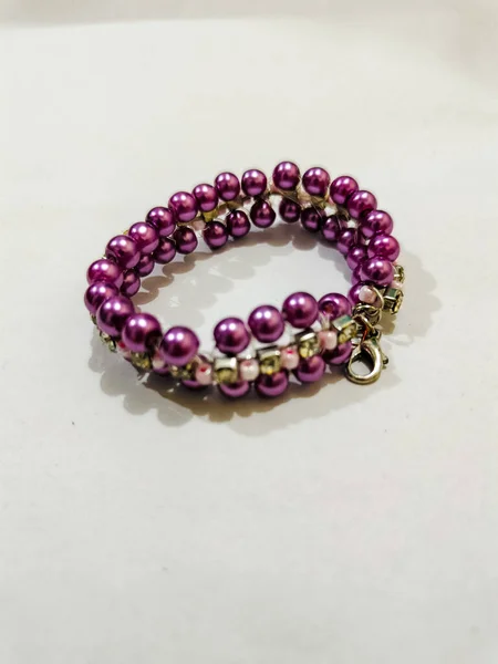 Purple beads bracelet on the white background