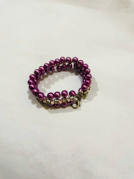 Purple beads bracelet on the white background