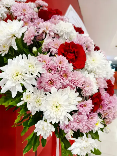 a beautiful bouquet of red, pink, and white flowers