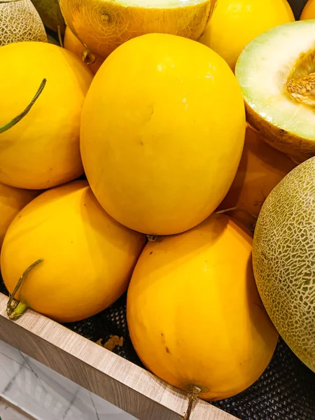 A pile of yellow melon fruits. No people.