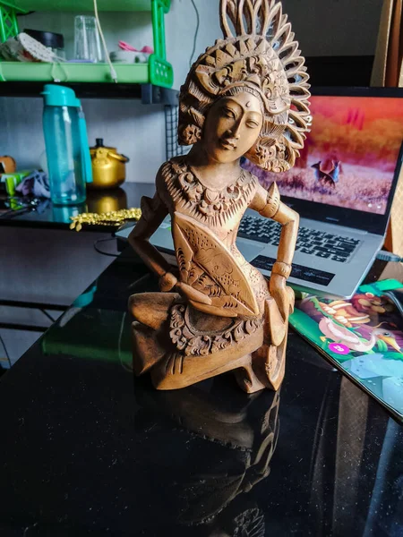 Wooden carving. A female fan dancer.