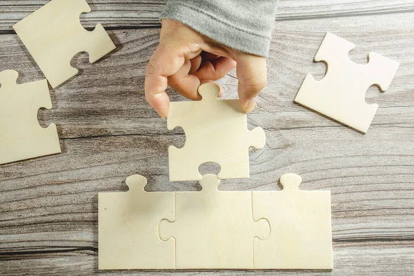 stock image White jigsaw puzzle connecting together. Team business success partnership or teamwork concept. A group of business people assembling jigsaw puzzle.Business woman hands connecting jigsaw puzzle. Business solutions, success and strategy concept. Close