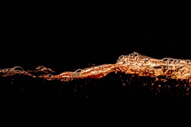 Yağ sıçraması ve hava kabarcıkları siyah arka planda izole edilmiş. Sarı Altın rengi su dalgası soyut arkaplan izole