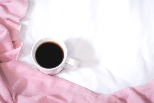 pink coffee and bed on white table