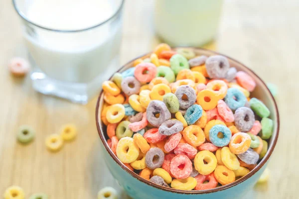 stock image Bowl of colorful children's cereal and milk isolated on wood table with Text space