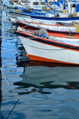 Prows of boats in battery moored to the pier