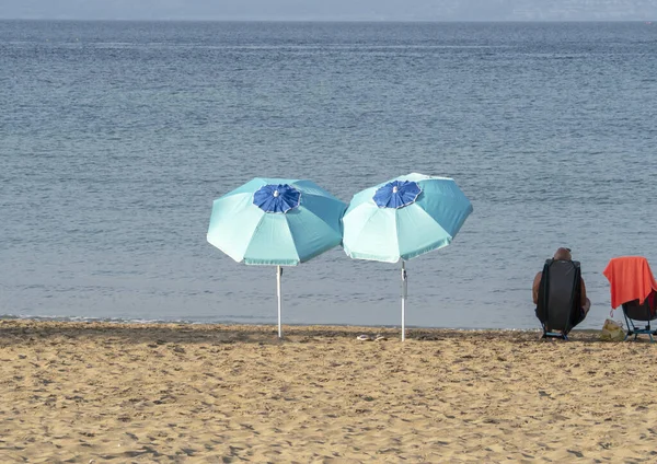 Blue Umbrellas Beach Black Red Touch — Stock Photo, Image