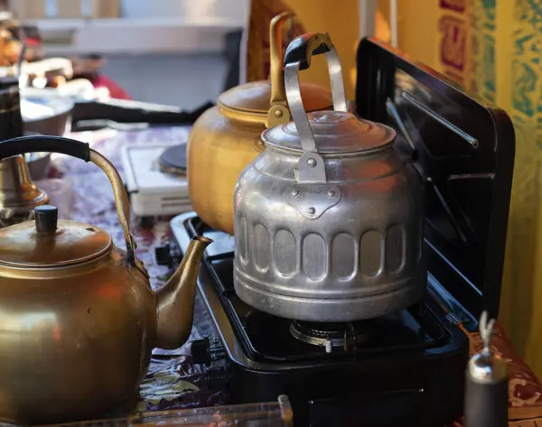 Preparing tea in a tent with a portable stove