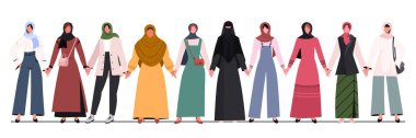 Group of young Muslim women in traditional hijabs and trendy clothes standing together and  holding hands. Concept of community, support, partnership, teamwork, social movement, unity, friendship and cooperation.